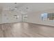 Bright living room featuring vaulted ceilings, modern lighting, and wood-look flooring at 1628 Izabella Ave, Las Vegas, NV 89169