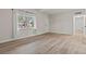 Cozy living room showcases wood-look flooring, bright natural light, and white trim at 1628 Izabella Ave, Las Vegas, NV 89169