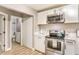 Modern kitchen featuring sleek white cabinets, stainless steel appliances, and stylish accents throughout at 1820 Yale St, North Las Vegas, NV 89030