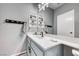 Bathroom with white vanity, granite counters, modern fixtures, large mirror, and decorative wall accents at 200 Teller St, Henderson, NV 89074
