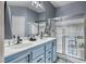 Updated bathroom featuring a double sink vanity, lots of light and a glass-enclosed shower at 200 Teller St, Henderson, NV 89074