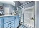 Bright bathroom featuring a single sink vanity, updated lighting, and a glass-enclosed shower at 200 Teller St, Henderson, NV 89074