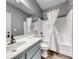 Bathroom featuring shower over tub, large vanity mirror, and modern fixtures at 200 Teller St, Henderson, NV 89074