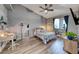 Bright bedroom with vaulted ceilings, wood-look floors, stylish decor, and plenty of natural light at 200 Teller St, Henderson, NV 89074