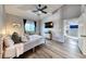 Cozy bedroom featuring wood-look floors, ample natural light, vaulted ceilings, and a ceiling fan at 200 Teller St, Henderson, NV 89074