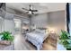 Well-lit bedroom featuring wood-look floors, stylish decor, vaulted ceilings, and access to the ensuite at 200 Teller St, Henderson, NV 89074