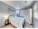 Cozy bedroom featuring a queen-sized bed, wood floors, and natural light from a window at 200 Teller St, Henderson, NV 89074