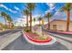 A beautiful community entrance with palm trees and manicured landscaping welcomes you to Rainbow Villas at Ventana Canyon at 200 Teller St, Henderson, NV 89074
