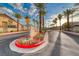 Welcome to Rainbow Villas - a picturesque street view with palm trees and meticulous landscaping at the community entrance at 200 Teller St, Henderson, NV 89074