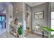 Bright and airy entryway featuring stylish decor, tile flooring and access to the bathroom at 200 Teller St, Henderson, NV 89074
