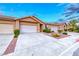Attractive single story home featuring an attached garage, wide driveway and desert landscaping at 200 Teller St, Henderson, NV 89074