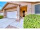 Inviting single story home featuring an attached garage, covered entryway and well-manicured landscaping at 200 Teller St, Henderson, NV 89074