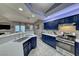 Updated kitchen with stainless steel appliances, a breakfast bar, and seamless flow into the living area at 200 Teller St, Henderson, NV 89074