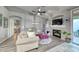 Comfortable living room with a fireplace, ceiling fan, modern decor and lots of natural light at 200 Teller St, Henderson, NV 89074