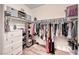 Walk-in closet with laminate floors, a dresser, and custom shelving with organizational accessories at 200 Teller St, Henderson, NV 89074