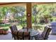 Relaxing covered back patio with stylish furniture and an inviting view of the landscaped backyard at 2026 Poppywood Ave, Henderson, NV 89012