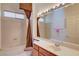 Well-lit bathroom features a shower-tub combo and large vanity area with ample counter space at 2026 Poppywood Ave, Henderson, NV 89012