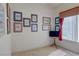 Decorated bedroom with a collection of framed artwork and a window with covering at 2026 Poppywood Ave, Henderson, NV 89012