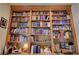 Extensive built-in bookshelves filled with a large collection of books and decorative items at 2026 Poppywood Ave, Henderson, NV 89012