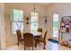 Cozy breakfast nook with a round table set and bright natural light streaming through the window at 2026 Poppywood Ave, Henderson, NV 89012