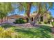 Inviting home exterior with mature trees shading the lush green lawn, complete with a manicured garden at 2026 Poppywood Ave, Henderson, NV 89012