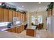 Well-lit kitchen with abundant cabinet storage, granite countertops, and a convenient center island at 2026 Poppywood Ave, Henderson, NV 89012