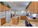 Traditional-style kitchen features wood cabinets, a kitchen island, and updated, modern appliances at 2026 Poppywood Ave, Henderson, NV 89012