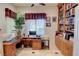 Well-organized office with built-in bookshelves, a large desk, and a window with shutters at 2026 Poppywood Ave, Henderson, NV 89012