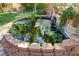 Close-up view of the backyard pond and water feature with vibrant greenery at 2026 Poppywood Ave, Henderson, NV 89012