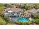 Aerial view of a luxurious home with a pool, outdoor seating, and meticulously landscaped grounds at 2058 Troon Dr, Henderson, NV 89074