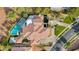 Aerial view showcasing the expansive property with a pool, lush landscaping, and a multi-car driveway at 2058 Troon Dr, Henderson, NV 89074