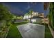 Spacious backyard offers a playhouse, artificial turf, a concrete patio and convenient access to the pool area at 2058 Troon Dr, Henderson, NV 89074