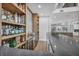 Wet bar with stone countertop, custom shelves, and stainless steel beverage cooler at 2058 Troon Dr, Henderson, NV 89074