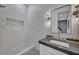 Modern bathroom showcasing textured walls, built-in shower niche, and elegant fixtures at 2058 Troon Dr, Henderson, NV 89074