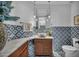Stylish bathroom featuring a marble countertop, vessel sink, modern vanity, and designer tile at 2058 Troon Dr, Henderson, NV 89074