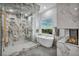Luxurious bathroom with marble shower, freestanding tub, and golf course view offers a spa-like experience at 2058 Troon Dr, Henderson, NV 89074
