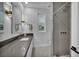 Modern bathroom features a gray countertop, decorative floor tiles, and a textured tile shower with a rainfall shower head at 2058 Troon Dr, Henderson, NV 89074