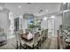 Spacious dining room featuring an oversized table with pendant lighting and modern decor at 2058 Troon Dr, Henderson, NV 89074