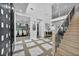 Grand foyer featuring tile accents, wood floors, high ceilings, and a staircase with iron railing at 2058 Troon Dr, Henderson, NV 89074