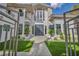 Elegant front entrance with double doors, artificial grass, and manicured landscaping at 2058 Troon Dr, Henderson, NV 89074