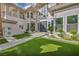 Gorgeous front entrance showcasing double doors, lush turf, and mature landscaping at 2058 Troon Dr, Henderson, NV 89074