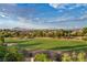 Expansive golf course view with lush green grass, mature trees, and mountain views in the background on a clear day at 2058 Troon Dr, Henderson, NV 89074
