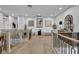 Well-lit upper hallway featuring wood floors, modern railings, and decorative art at 2058 Troon Dr, Henderson, NV 89074