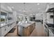 Spacious kitchen with island, stainless steel appliances, and open floor plan to dining and living areas at 2058 Troon Dr, Henderson, NV 89074