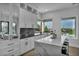 Elegant kitchen with white cabinetry, marble countertops, and a view to the backyard pool at 2058 Troon Dr, Henderson, NV 89074