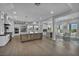 Bright, open kitchen featuring a large island, stainless steel appliances, and adjacent dining area at 2058 Troon Dr, Henderson, NV 89074
