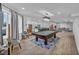 Bright living room with a pool table, games, ample seating, and modern decor at 2058 Troon Dr, Henderson, NV 89074