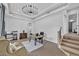 This office features a tray ceiling, unique chandelier, and a cozy sitting area at 2058 Troon Dr, Henderson, NV 89074