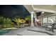 Well-appointed patio area features comfortable seating, a built-in barbecue, and a serene view of the pool at twilight at 2058 Troon Dr, Henderson, NV 89074