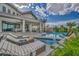 Luxury pool area with lounge chairs, patio, and lush landscaping, perfect for relaxation and entertaining at 2058 Troon Dr, Henderson, NV 89074